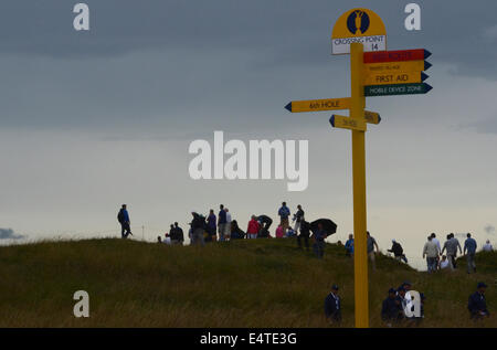 Royal Liverpool Golf club, Hoylake, UK. 16th July, 2014.  Spectators prepare for wet weather as the sky gets darker Credit:  rsdphotography/Alamy Live News Stock Photo