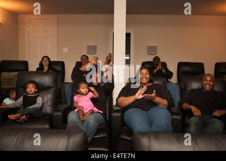 Extended Family Watching Movie in Home Theater Stock Photo