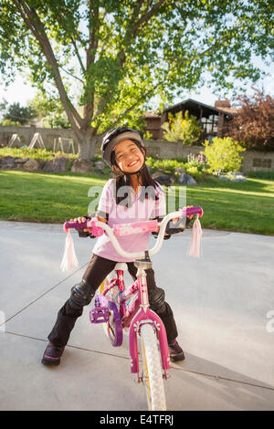 Portrait of Girl Riding Bike with Safety Gear, Utah, USA Stock Photo