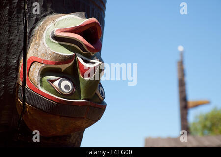 A close-up of an upside down totem carving on a Kwakwa̱ka̱’wakw honouring totem pole in Thunderbird Park, Victoria, Canada. Stock Photo