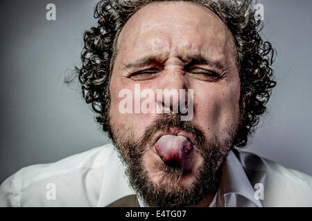 derision, man with intense expression, white shirt Stock Photo