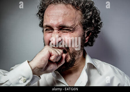 derision, man with intense expression, white shirt Stock Photo