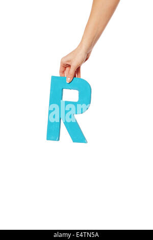 hand holding up the letter R from the top Stock Photo