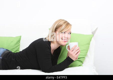 Young woman enjoying a cup of coffee Stock Photo