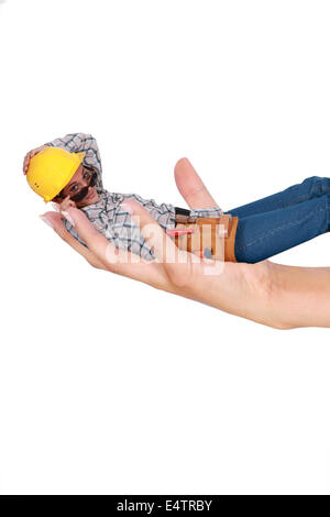 Woman carpenter laid in a hand Stock Photo