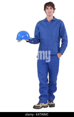 A construction worker dressed all in blue. Stock Photo