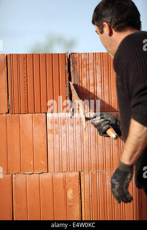 Mason cementing between bricks Stock Photo