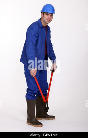 Man holding bolt cutters Stock Photo