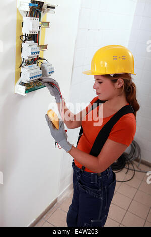 Female electrician with a fuse box Stock Photo