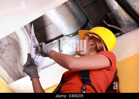 Woman checking ventilation system Stock Photo