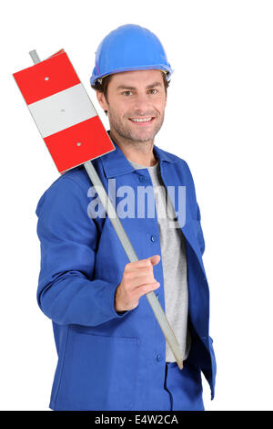 Builder holding road sign. Stock Photo