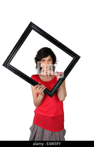 Woman with black frame in hand Stock Photo