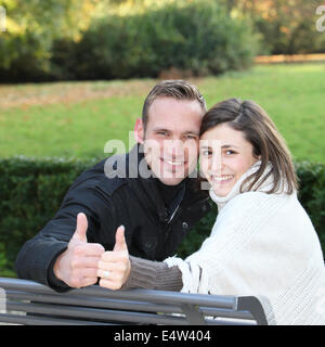 Happy young couple giving a thumbs up Stock Photo