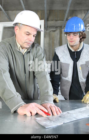 Electrician with young apprentice Stock Photo