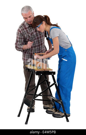 Man and woman doing carpentry work Stock Photo