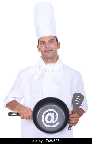 Male chef holding frying pan Stock Photo