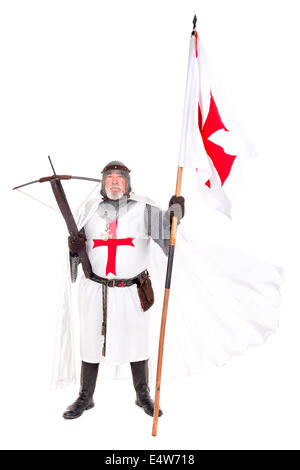 Knight Templar posing with crossbow and flag isolated in white Stock Photo