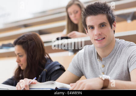 Student looking up from lecture and smiling Stock Photo