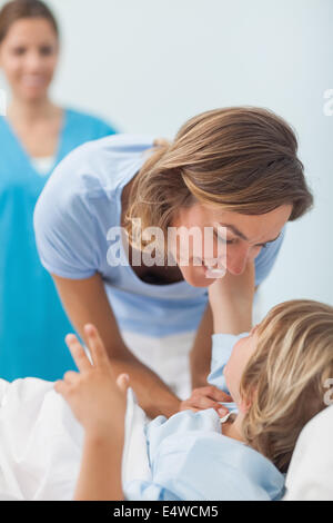 Child on a medical bed looking his mother Stock Photo