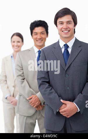 Smiling young salesteam standing in line Stock Photo