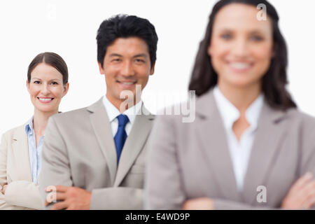 Smiling salesteam standing with arms folded Stock Photo