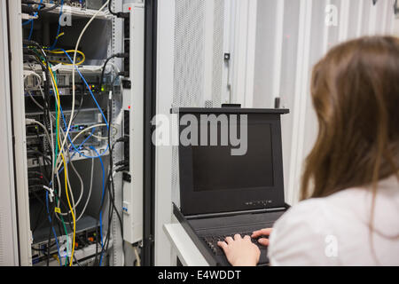 Woman storing data on server Stock Photo