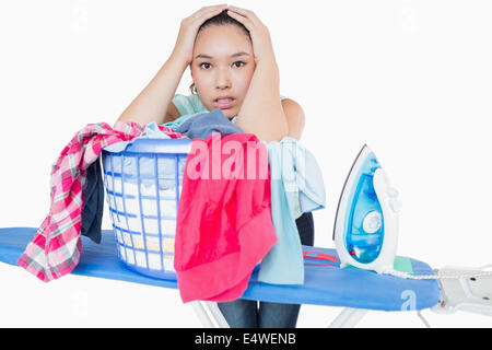 Woman fed up with ironing Stock Photo