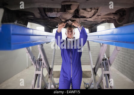Mechanic repairing a car with tools Stock Photo