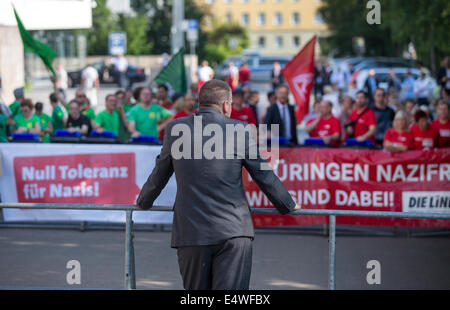 Erfurt, Germany. 17th July, 2014. NPD state party chairman Patrick Wieschke looks at counter demonstrators during a demonstration by his party outside of the Thuringian parliament in Erfurt, Germany, 17 July 2014. The NPD members wanted to attend the last session of parliament before the state parliamentary elections as visitors but they were blocked by counter demonstrators. Photo: MICHAEL REICHEL/dpa/Alamy Live News Stock Photo