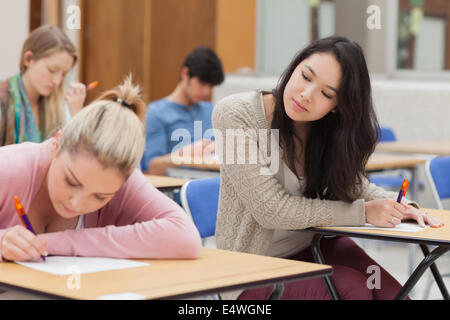 Girl copying another students work in exam Stock Photo