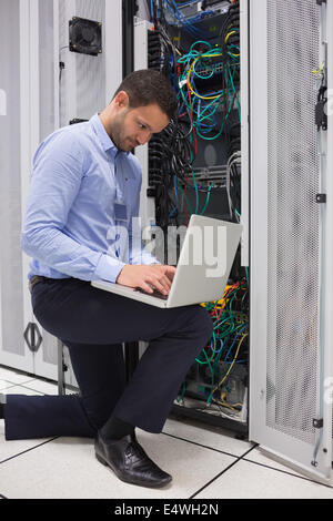 Concentrated technician doing data storage Stock Photo