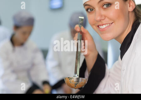 Happy chef about to taste soup Happy chef about to taste soup