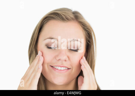 Pretty woman putting her hands on face Stock Photo