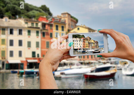 A woman photographing with mobile phone, Portofino, Cinque Terre, Italy Stock Photo