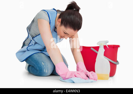 Serious cleaning woman wiping up the floor Stock Photo