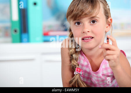Little girl holding crayon Stock Photo