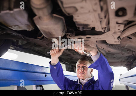 Mechanic using tools Stock Photo