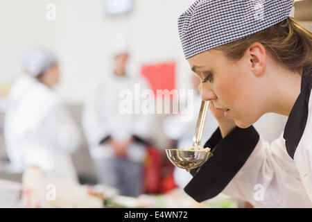 Chef smelling soup