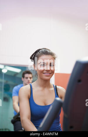 Woman on exercise bike in spinning class Stock Photo