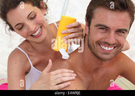 couple relaxing on the beach Stock Photo