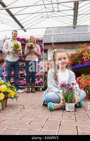 Happy family holding flower pots Stock Photo