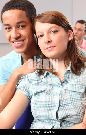 Couple sat in university lecture Stock Photo