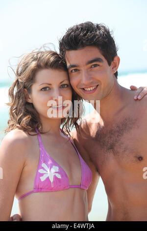 Affectionate young couple on the beach Stock Photo - Alamy