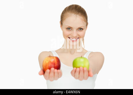 Smiling woman presenting two apples Stock Photo