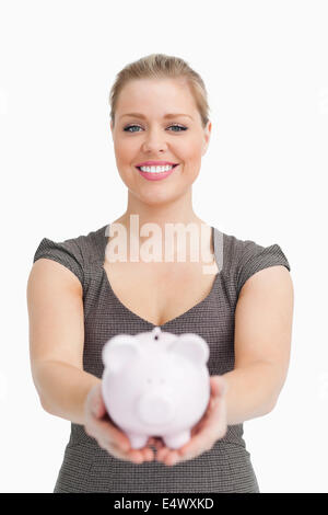 Piggy bank showing by a woman Stock Photo