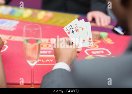 Man holding up poker hand Stock Photo