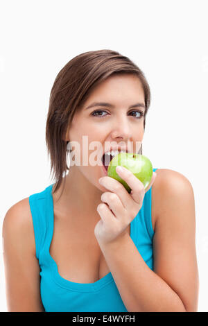 Attractive teenager eating a green apple Stock Photo