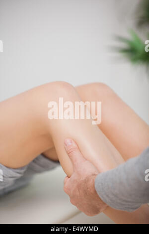 Close up of a masseur massaging a calf Stock Photo