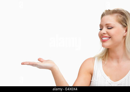 Cheerful woman placing her hand palm up Stock Photo