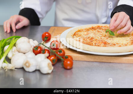 Pizza being garnished Stock Photo